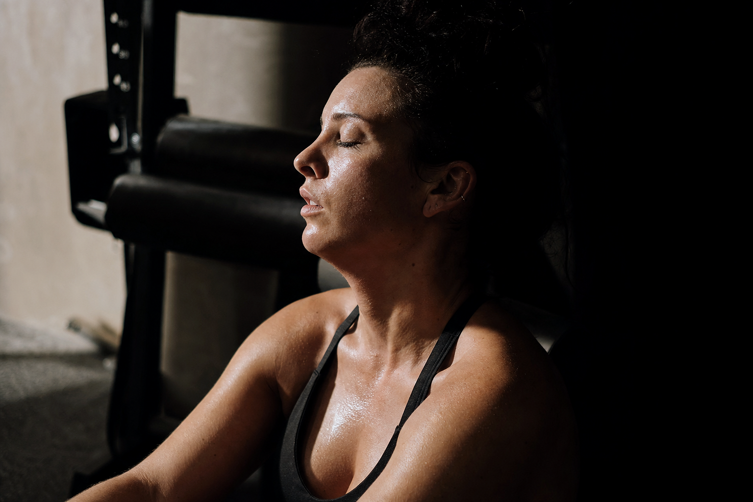 Strength Programming — PROFILE PORTRAIT of a person mid-treatment, eyes closed, soft side light