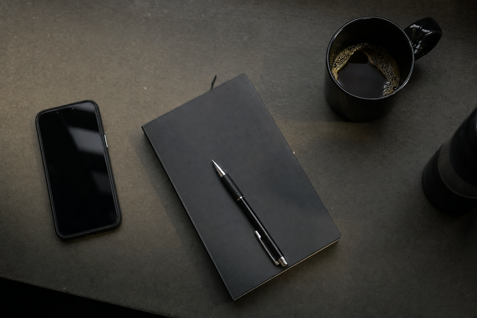 IRONROOT Athletic Club office — OVERHEAD FLAT-LAY of a desk: phone, notebook, coffee — minimal, top-down, daylight