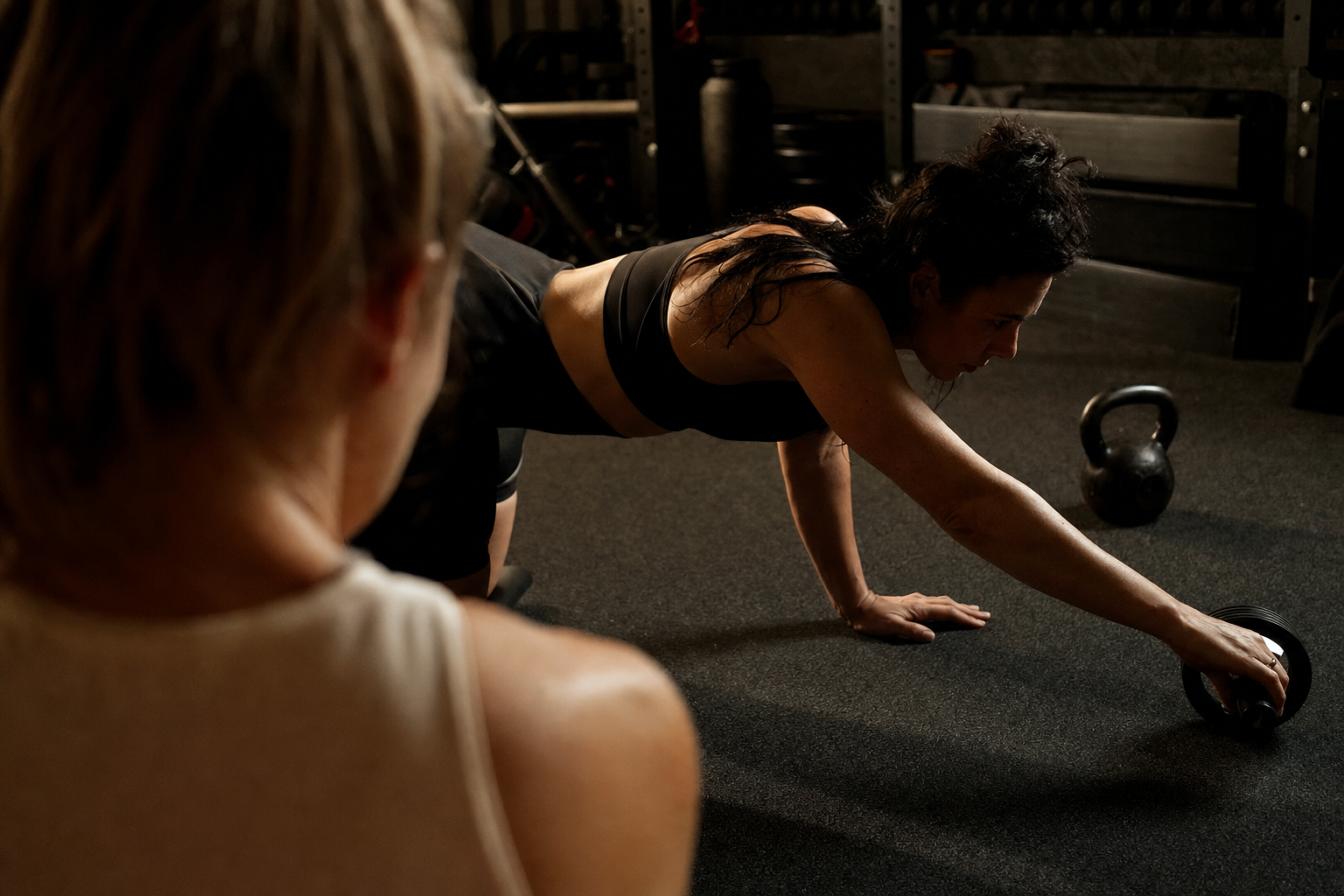 Small-Group Coaching — OVER-THE-SHOULDER perspective watching the practitioner work, soft natural light